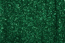 Green Sparkling Lights Festive Background With Texture. Abstract Christmas Twinkled Bright Bokeh Defocused And Falling Stars. Winter Card Or Invitation	