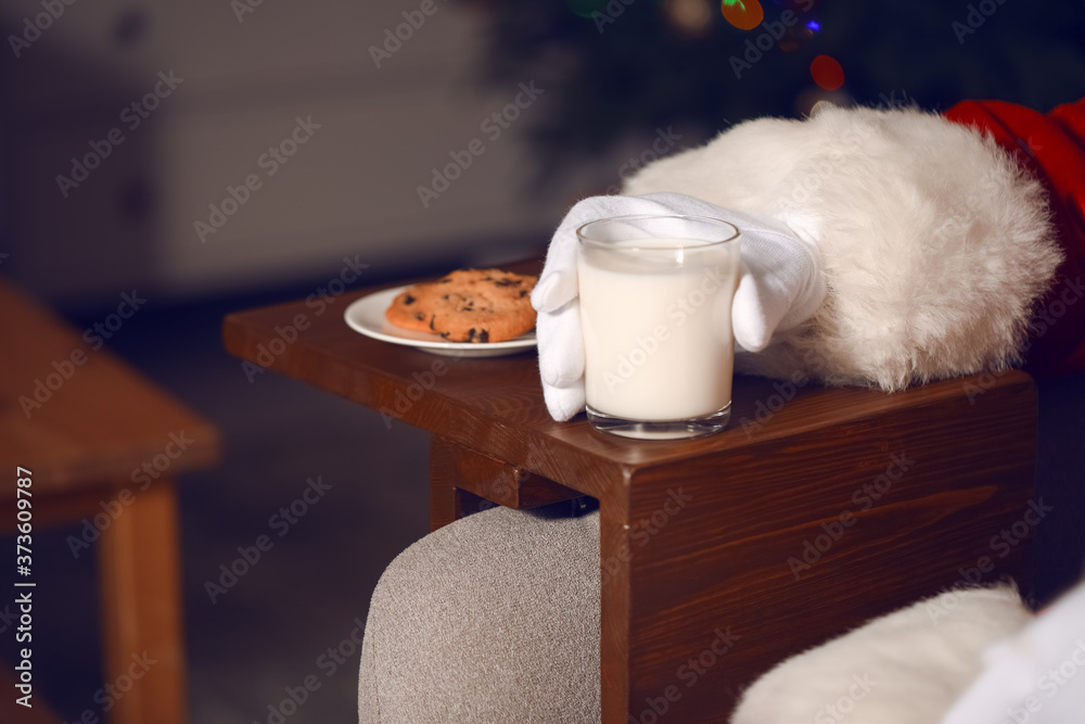 Santa Claus drinking milk and eating cookies, closeup