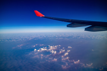 Aerial view during flight with clear blue sky and the cloud