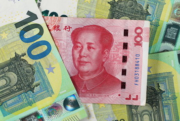 Chinese hundred yuan, renminbi banknotes and European hundred euro bills, cash money background and texture