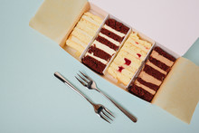 Cake Slices In A Box On A Light Background