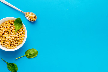 Wall Mural - Chickpeas dishes. Vegan healthy food on blue desk top view copy space