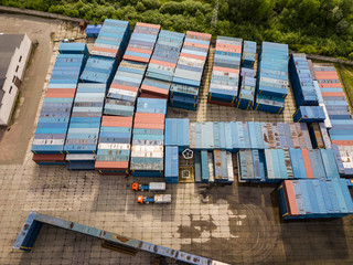 Multicolored freight containers on the railroad. Aerial drone view.