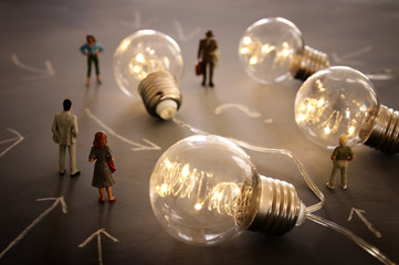 Wall Mural - Surreal image of people looking at glowing light bulbs. Concept of finding the right idea, or solution