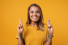 Image Of Blonde Excited Woman Holding Fingers Crossed For Good Luck