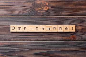 Wall Mural - OMNICHANNEL word written on wood block. OMNICHANNEL text on cement table for your desing, concept