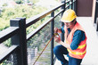 © khwanchai - construction worker use measuring tape of balcony