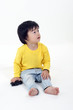 © oqba - South East Asian young boy child playing looking up on white background