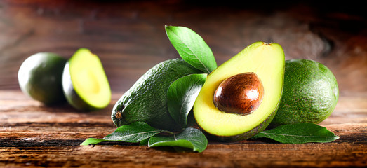 Avocado on rustic wooden table.