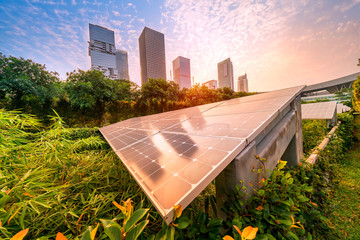 Wall Mural - ecological energy renewable solar panel plant with urban landscape landmarks