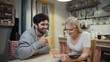 © stanis88 - Young couple drinking tea and discuss a book on a kitchen