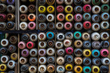 Fototapeta Młodzieżowe - Colorful spray graffiti paint bottles stacked to be a background image, Karakoy, Istanbul, Turkey
