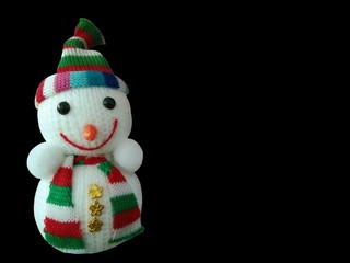 Christmas smile yarn snowman isolated on black background with copy space.