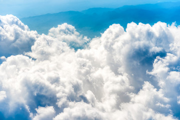 Wall Mural - White clouds on blue sky with above aerial view from a plane, nature blue sky background