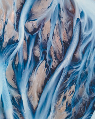 Wall Mural - A glacial rivers from above. Aerial photograph of the river streams from Icelandic glaciers. Beautiful art of the Mother nature created in Iceland. Wallpaper background high quality photo