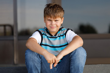 Poster - handsome boy striped jumper sitting on steps in parks