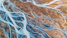 A Glacial Rivers From Above. Aerial Photograph Of The River Streams From Icelandic Glaciers. Beautiful Art Of The Mother Nature Created In Iceland. Wallpaper Background High Quality Photo