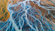 Leinwandbild Motiv A glacial rivers from above. Aerial photograph of the river streams from Icelandic glaciers. Beautiful art of the Mother nature created in Iceland. Wallpaper background high quality photo