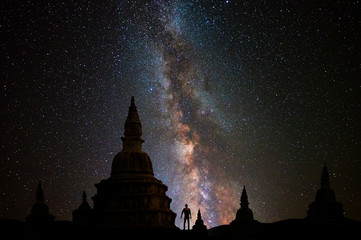 Wall Mural - buddhist temples with milky way background