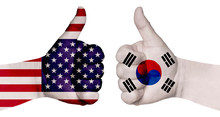 Two Hands Are Painted With Flags Of Different Countries, With A Thumb Raised Up. South Korea And The USA