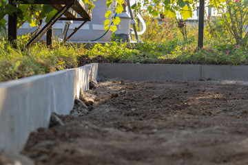 Installation of the Curb before laying paving slabs. Reconstruction of the sidewalk and replacement of old curbs. Repair of the sidewalk. Selective focus.