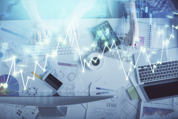 Double exposure of man and woman working together and financial chart hologram drawing. market analysis concept. Computer background. Top View.