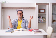 Young Male Student Preparing For Exam At Home
