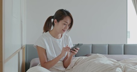 Poster - Woman use of cellphone on bed