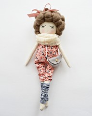 Wall Mural - Heirloom textile doll with curly hair wearing cute floral overalls, felt gray handbag, striped gaiters and vanilla guipure scarf	