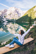 © phpetrunina14 - woman sitting on the bench looking at pragser wildsee in north italy