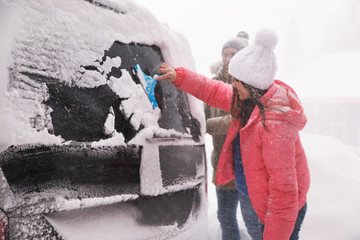 Poster - Man cleaning snow from car outdoors on winter day