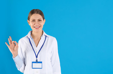 Sticker - Portrait of young doctor on blue background, space for text