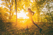 © Maridav - Sport running girl athlete jogging in autum foliage forest. Fall outdoor activity.
