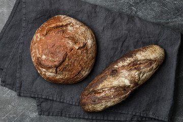 Rustic bread on dark background. Flat lay.