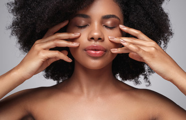 Wall Mural - Ethnic woman applying cream on face