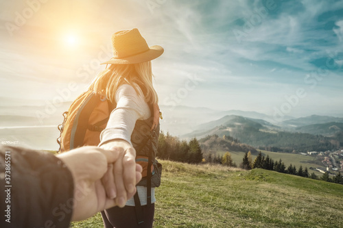 Fotomural Woman hiker, hiking backpacker traveler camper walking on the top of mountain in sunny day under sun light