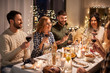 © Syda Productions - holidays, celebration and people concept - happy friends having christmas dinner at home drinking non-alcoholic red wine