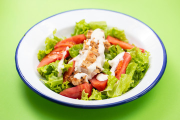 Sticker - fresh salad with grilled chicken and sauce on the plate