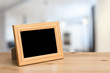 © vlntn - photo frame on the wooden table