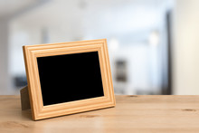 Photo Frame On The Wooden Table