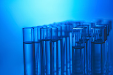 Many test tubes on color background, closeup