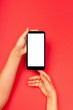© elena_fedorina - Smart phone in child's hands on the red background. The concept of digital, necessary things of a little girl, technology for children. Flat lay, copy space, isolated white display.