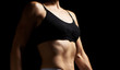 © nndanko - muscular abs on the stomach of a caucasian woman in a black bra