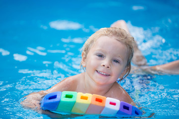 Sticker - Cute toddler boy, swimming in pool with board