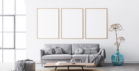 Wall Mural - Frame mockup in interior living room design. Three vertical frames on white background with big window. modern grey sofa with plaid on, blue vase, and natural wooden table. Scandinavian home decor