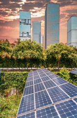 Wall Mural - ecological energy renewable solar panel plant with urban landscape landmarks