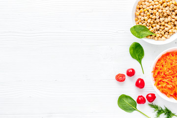 Wall Mural - Vegetarian bowl with chickpeas and vegetables - white table top view copy space