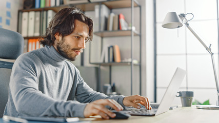 Poster - Handsome Long Haired Hispanic Businessman Sitting at His Desk in the Office Works on a Laptop. Creative Developing New Software Unicorn Startup Project, Finalizing Business Transaction