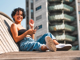 Sticker - Attractive female with a mobile enjoying the day outdoors