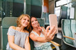 © pavelgulea - Two women taking selfie in train showing peace sign